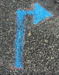 Blue Arrow Painted on Pavement Pointing