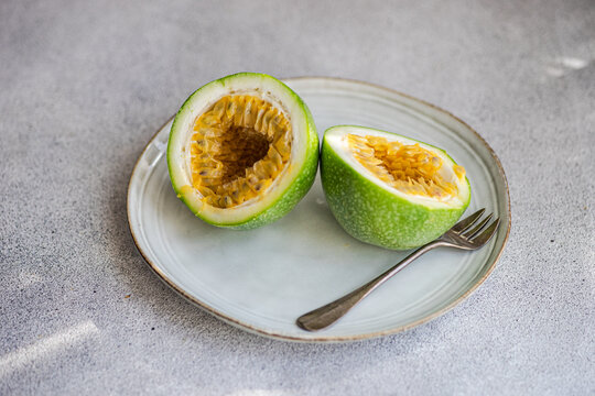 Close-up of a halved passion fruit on a plate