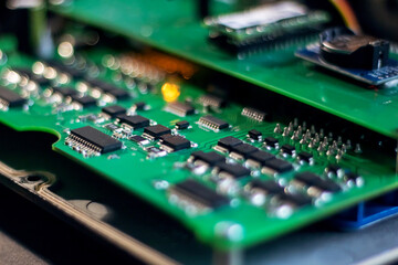 Green motherboard and transistors closeup macro photography