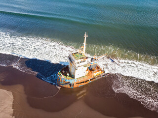 A sunken ship washed ashore Iturup, Kuril Islands. Russia - 745288798