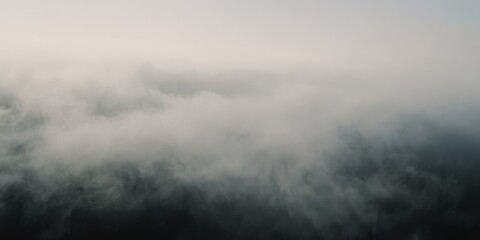 Panoramic view of an abstract fog with white cloudiness moving on a black background with copy space for text