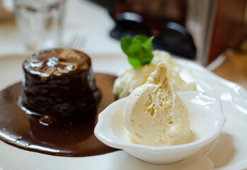 appetizing dessert ice cream and chocolate cake separation by depth of field