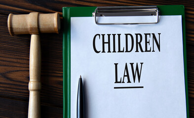 CHILDREN LAW - words on a white sheet with a judge's gavel - obrazy, fototapety, plakaty