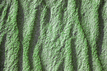 Waves on the surface of the sand, top view. The wavy surface of coastal sand. The structure of waves on sea sand.