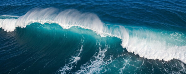 The majestic beauty of the ocean as viewed from a drone, showing the detailed textures and forms of waves crashing into the sea from a top view perspective.