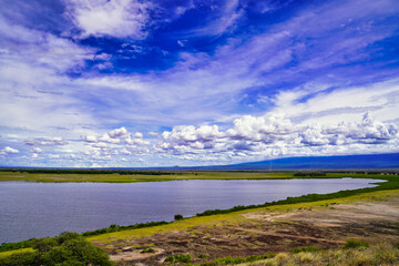 Endless vistas and bright blue skies over the great savanna plains and water bodies from the top of...