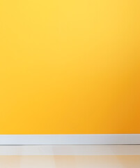 Bright yellow painted wall with white baseboard. Minimalistic textured background, copy space