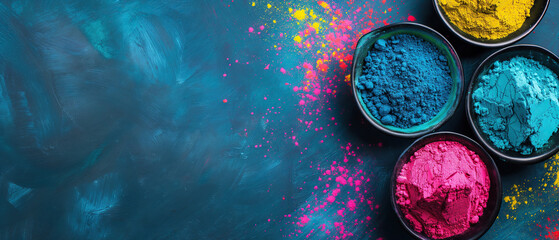 Obraz na płótnie Canvas Holi festival background with colorful powder in bowls, wide blue banner with copy space