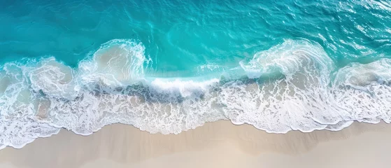 Foto op Canvas a bird's eye view of a beach with waves crashing on the sand and the ocean in the background. © Jevjenijs