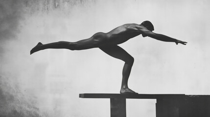 Man single leg balancing reversed diving pose.