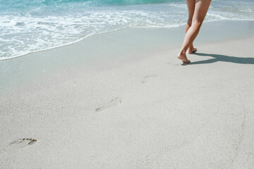 A Feet and footprints by the seashore in nature travel vacation background