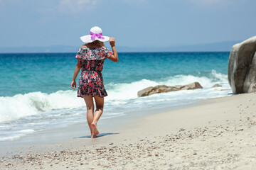 A Happy girl on the shore of the sea in travel vacation