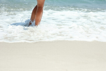 A Feet and footprints by the seashore in nature travel vacation background