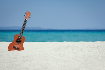A beautiful guitar on the sand by the Greek sea