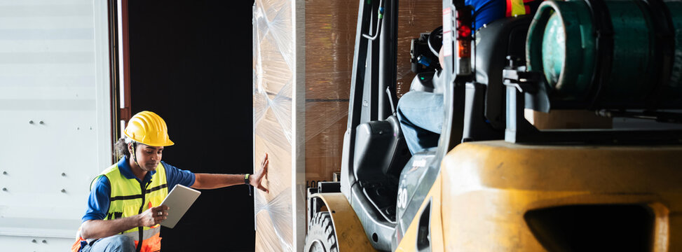 Warehouse worker workers with forklift in a warehouse. Use forklift operator moves packages. Concept industrial and commercial.