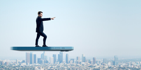 A dynamic male figure gestures commandingly towards a city horizon from atop a smartphone, denoting...
