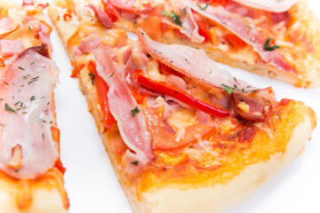 Pizza slice top view isolated on white background, with onions, bacon and cherry tomatoes, thin...