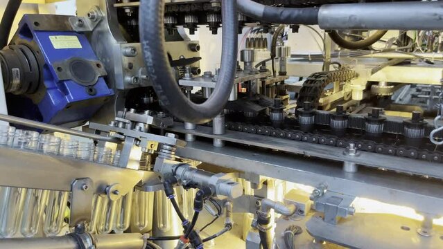 Plastic preforms entering heating zone of the blow machine