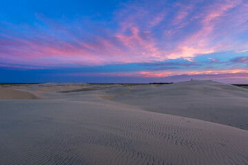 Fototapeta na wymiar Multicolored sunset on the dunes of Duck's Lake, southern Brazil