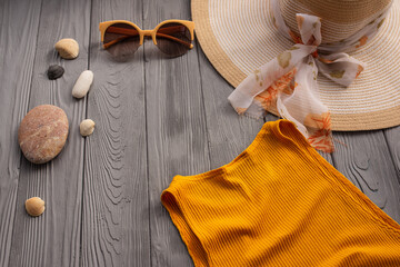 beachwear orange woman top outfit hat bag sun protection sunglasses pebbles.