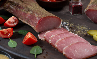 Meat dried pork ham cut into strips among vegetables and herbs