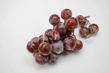 spoiled bunch of grapes with mold. food waste, recycling spoiled food concept