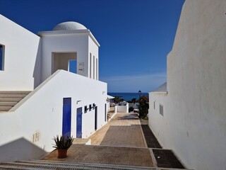 Pretty, traditional, whitewashed village in Lanzarote with green plant and details