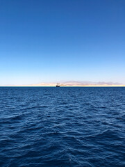 Ship yacht boat on horizon line Egypt. panoramic view blue sea surface far from coast.