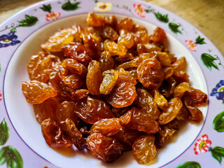 Raisins or dried grapes in a small plate
