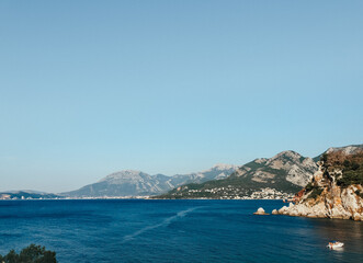 Naklejka premium Top view Montenegro Sutomore stones beach blue turquoise Adriatic sea water mountains day