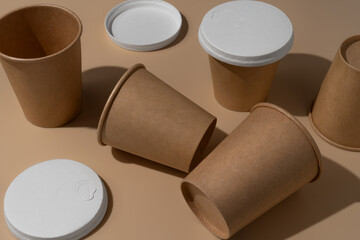 paper cups with recyclable cover on a beige background
