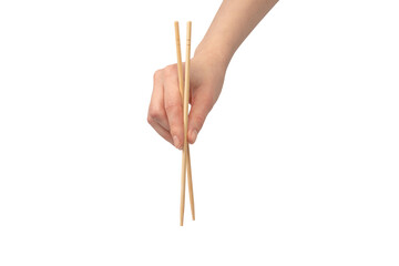 Female hand holding wooden sushi chopsticks isolated on white background.