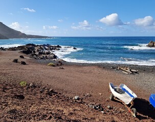 Fototapeta na wymiar Small colorfol boats on black volcanic beach of Lanzarote