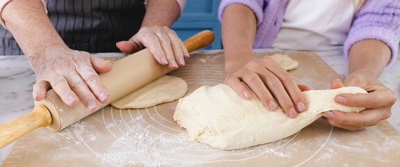 With love and tradition, mom and daughter come together in kitchen to make dough for their favorite...