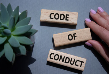Code of conduct symbol. Wooden blocks with words Code of conduct. Beautiful grey background with...