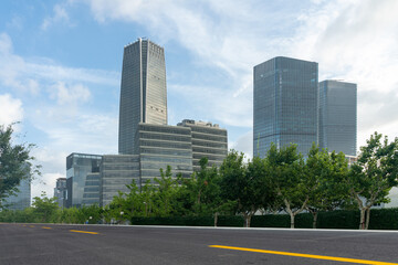 Fototapeta na wymiar empty asphalt road with modern office buildings in downtown.