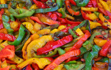 background of many Red green and yellow peppers seasoned with oil
