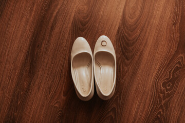 wedding ring lies on toe shoe. pair women formal high heel shoes