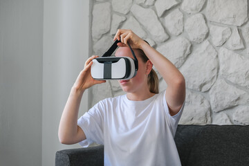 VR.woman uses VR glasses in everyday life at home, augmented reality, VR AR technologies, mixed reality,new future technology, futuristic environment,VR headset,immersive spaces