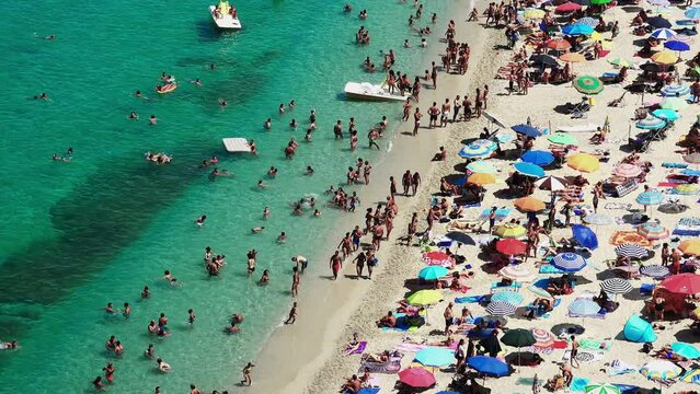 Top View Of A Beautiful Beach With Sunbathers On A Hot Day