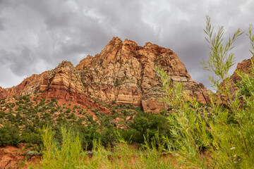 Gray sky and red rock mountain