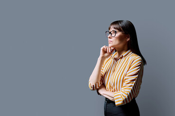 Profile portrait of mature confident serious woman on gray background © Valerii Honcharuk
