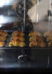 bakery baking croissants on industrial machine