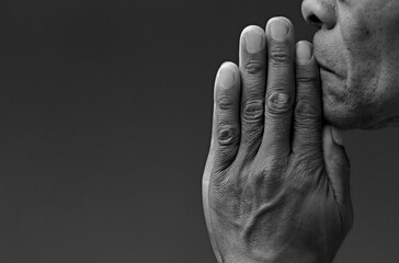 black man praying to god with hands together Caribbean man praying on black background with people...