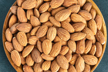 Close up with many fresh organic peeled almonds . Natural texture background.