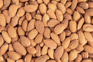 Close up with many fresh organic peeled almonds . Natural texture background.