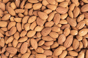 Close up with many fresh organic peeled almonds . Natural texture background.