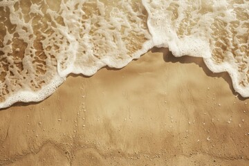 Serene Beach Wave Edge - The soft foam of a gentle wave caresses the golden sand, creating a peaceful seaside pattern.