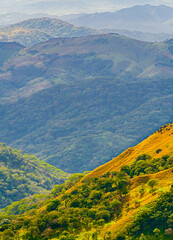 Verdant slopes of Monteverde under a dynamic sky, showcasing the rich biodiversity and layered mountain vistas of Puntarenas Province, Costa Rica. High quality photo.