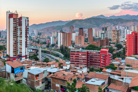 A stunning panoramic shot capturing the vibrant cityscape of Medellin at dusk, with a blend of residential areas and modern buildings